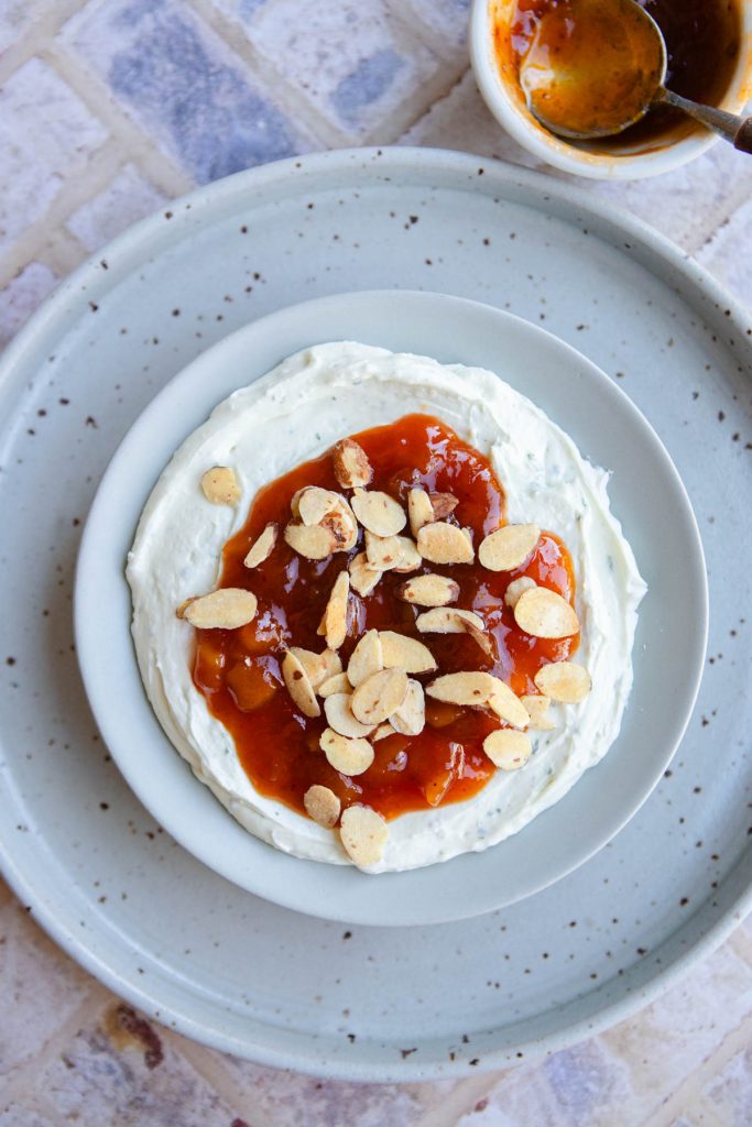 goat cheese dip with mango chutney spread out on a bowl