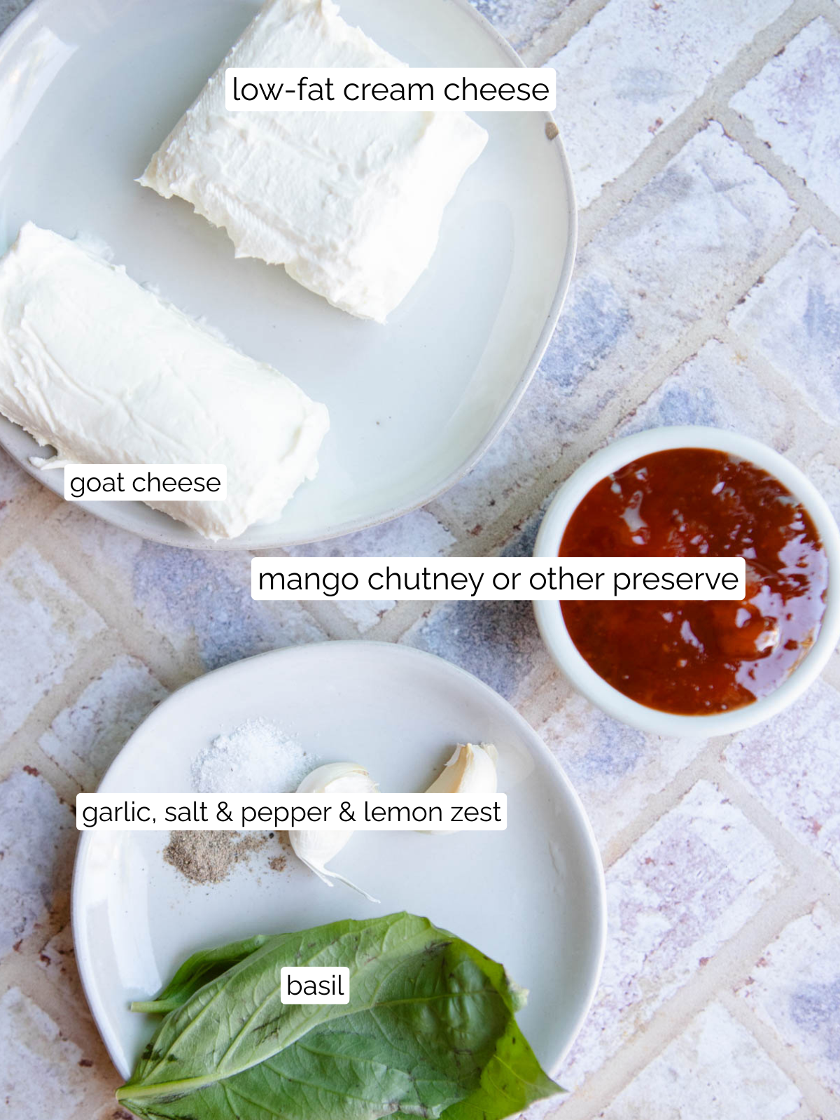 ingredients to make goat cheese dip on small white plates