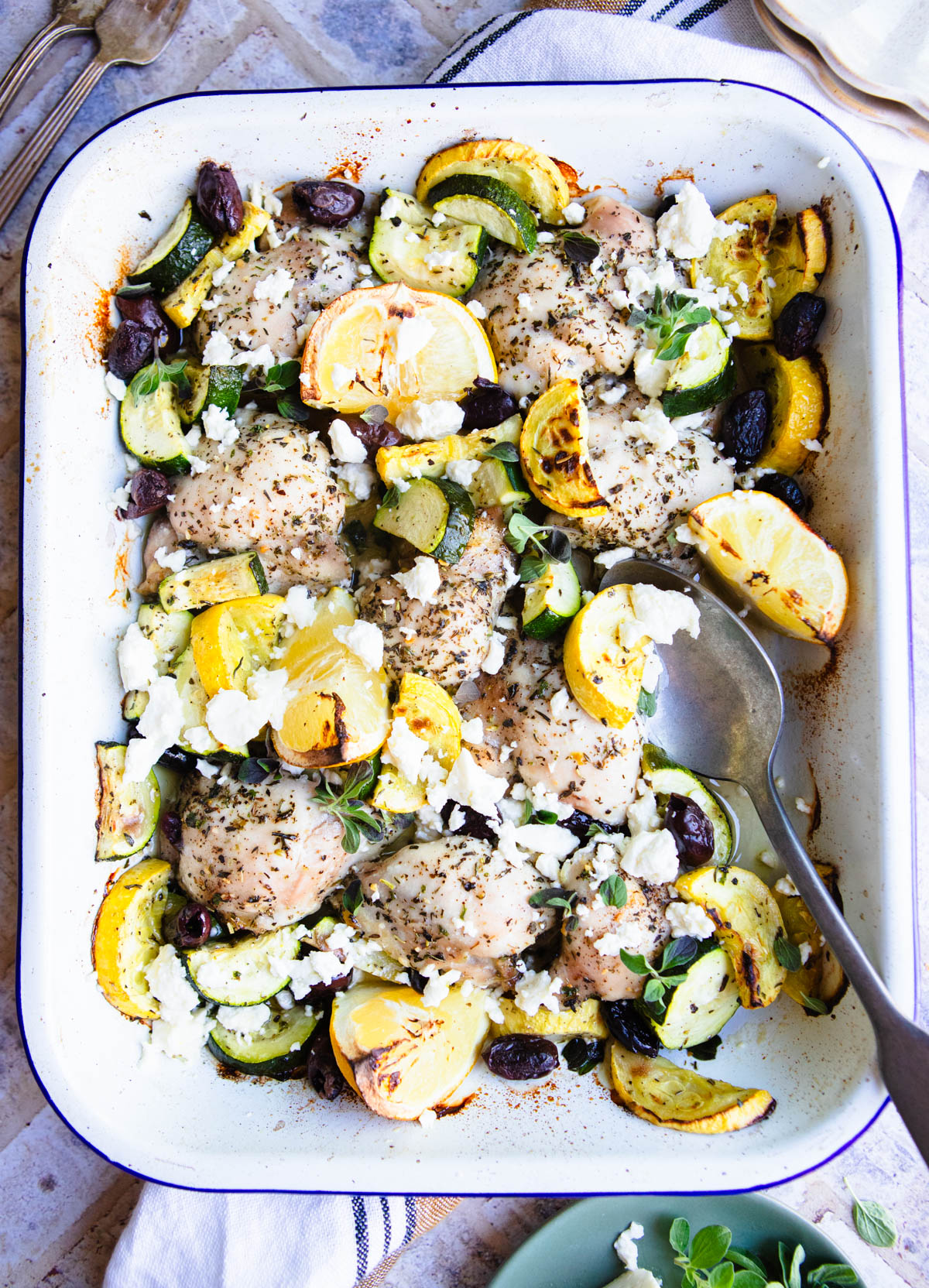 greek lemon chicken one pan meal in a white ceramic pan