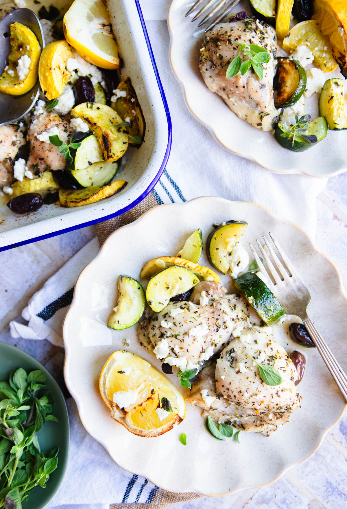 plated Greek chicken thighs with roasted vegetables, olives and feta cheese