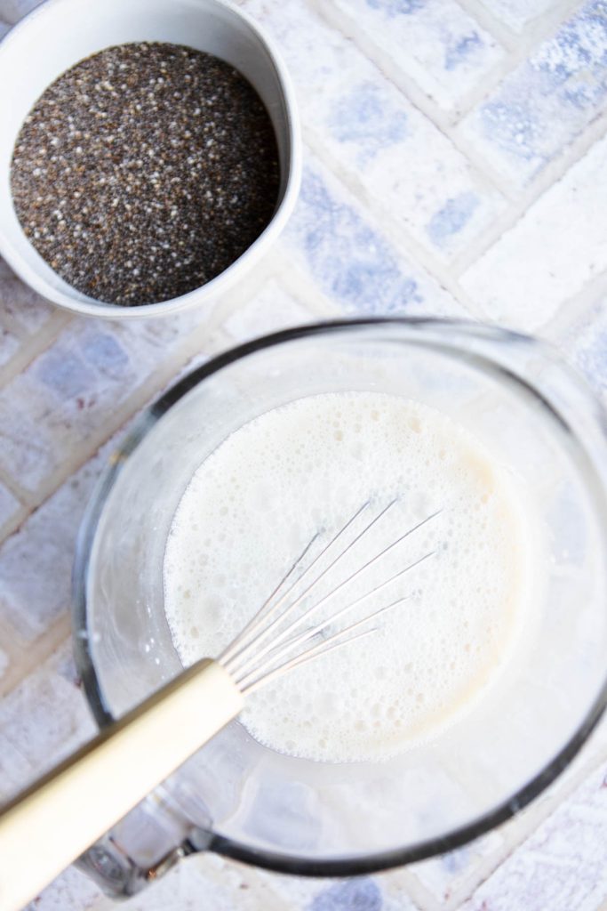 coconut milk and coconut water along with fresh ginger and maple syrup in a glass measuring cup