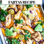 oven baked chicken fajitas on a sheet pan garnished with avocado and limes and cilantro