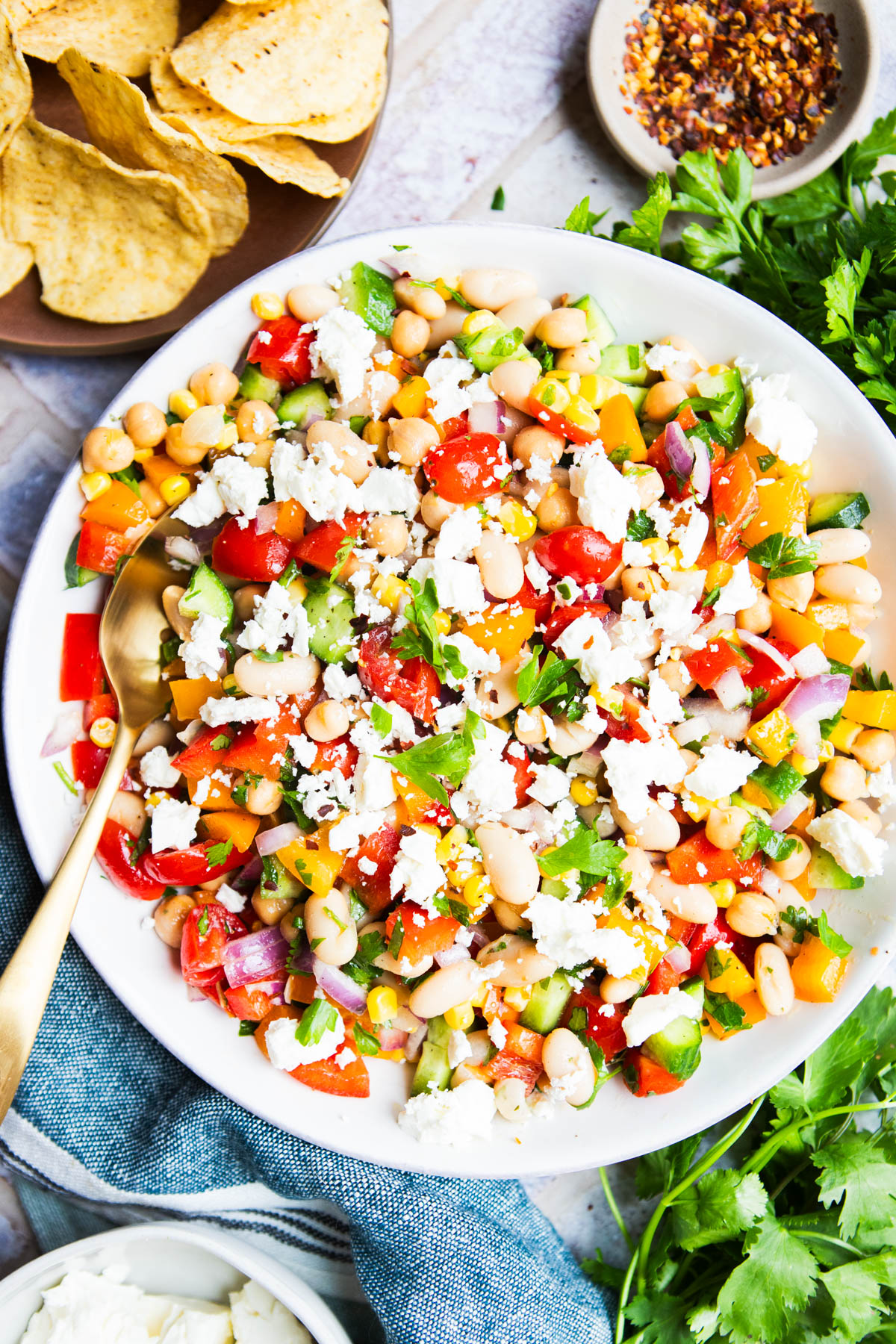 large serving bowl filled with cowboy caviar dip and topped with crumbled feta cheese
