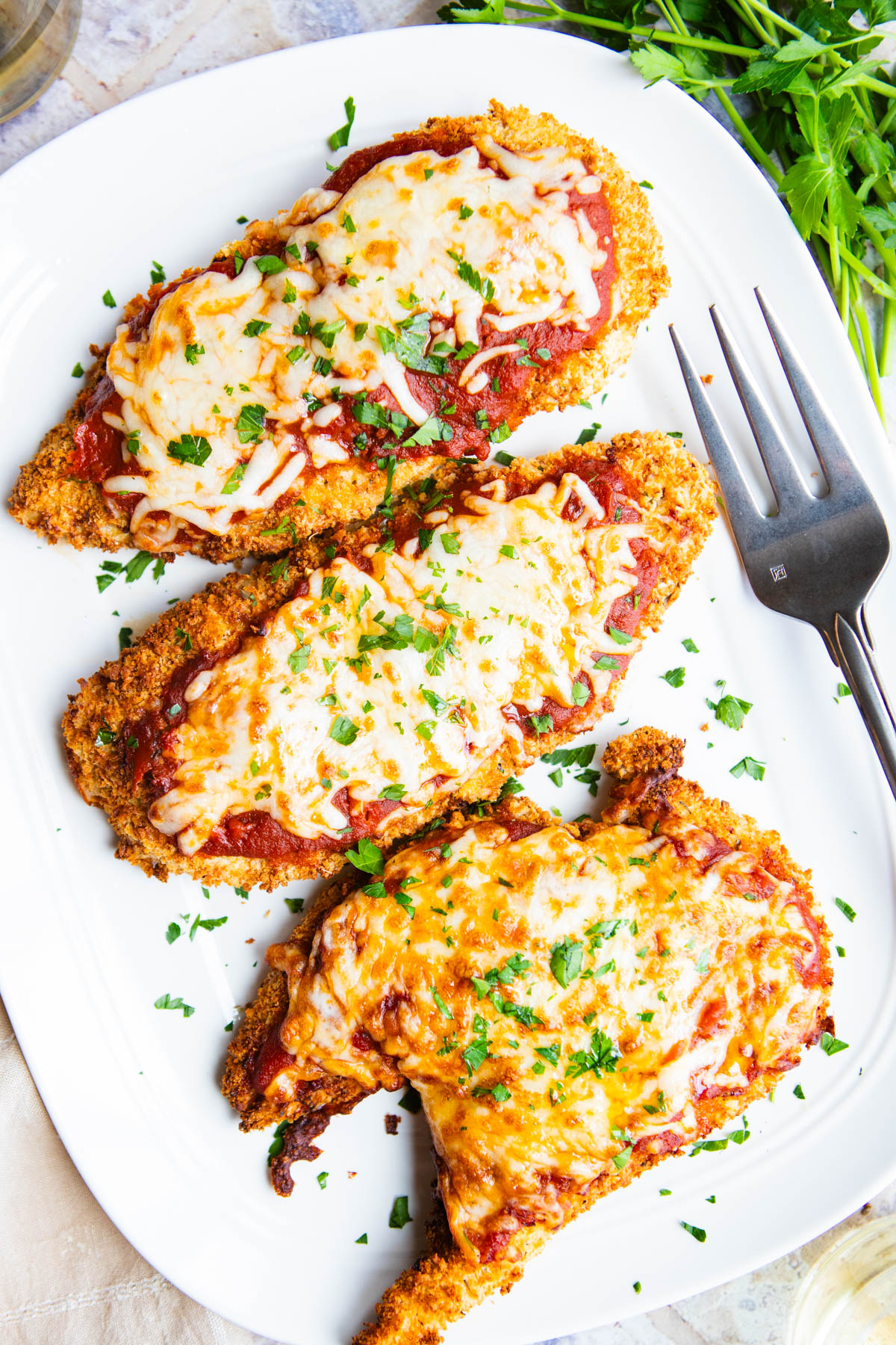 breaded chicken cutlets made in the air fryer and topped with mozzarella cheese and marinara sauce to make chicken parmesan