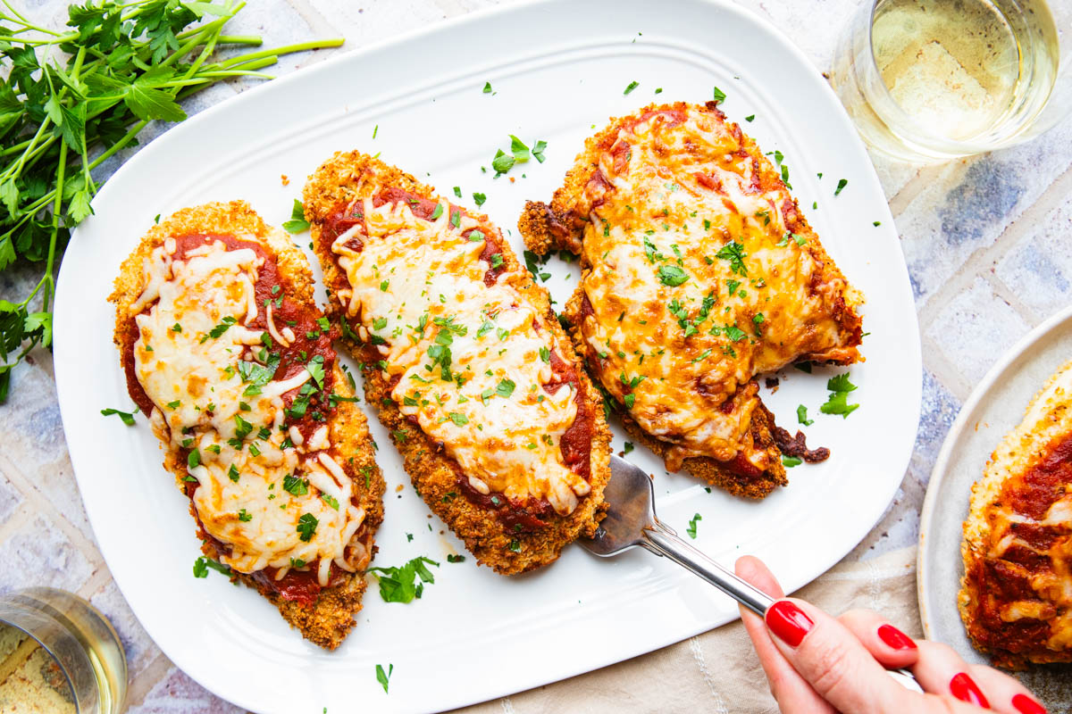 air fried chicken parmesan on a white ceramic serving platter