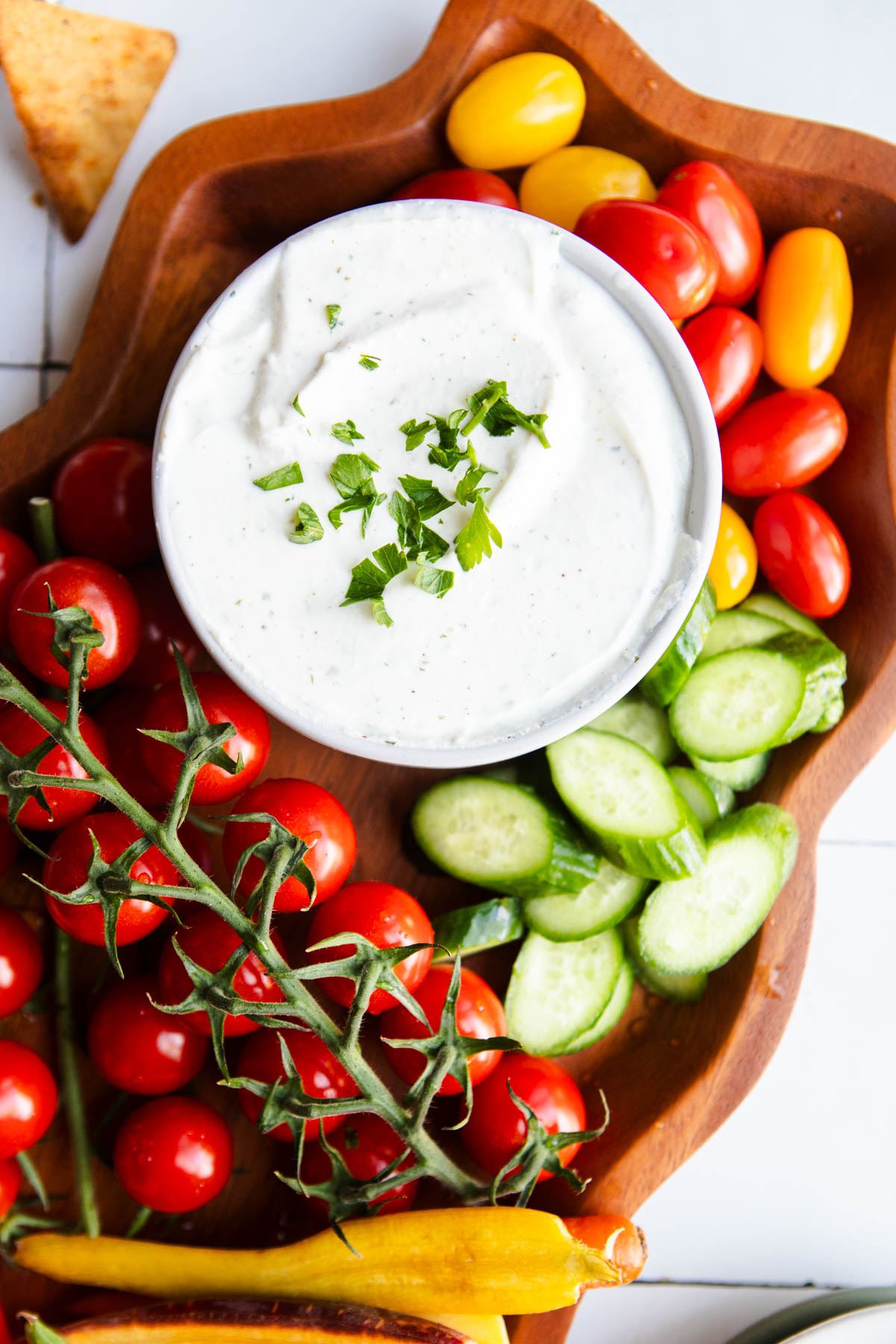 cottage cheese ranch dip with veggies on a wood platter 