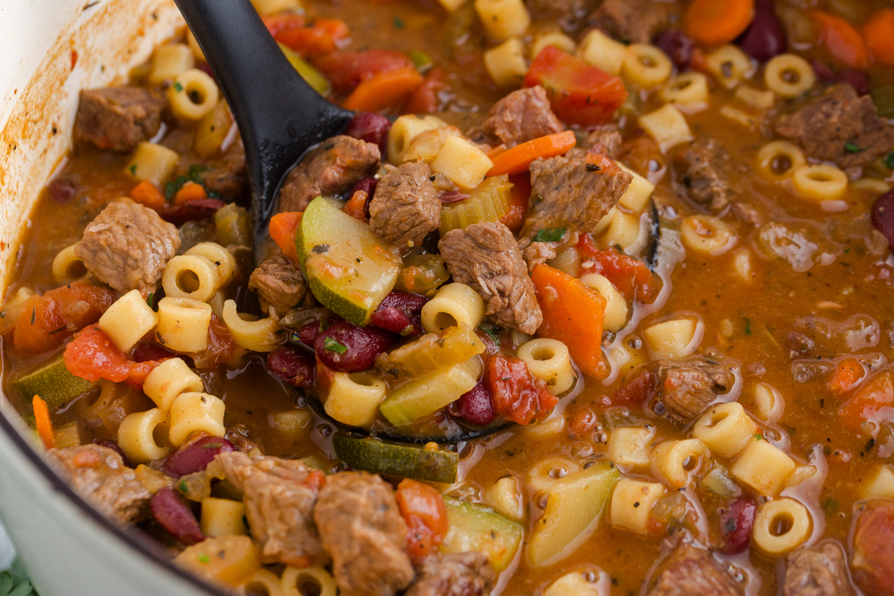 large Dutch oven filled with minestrone soup with beef