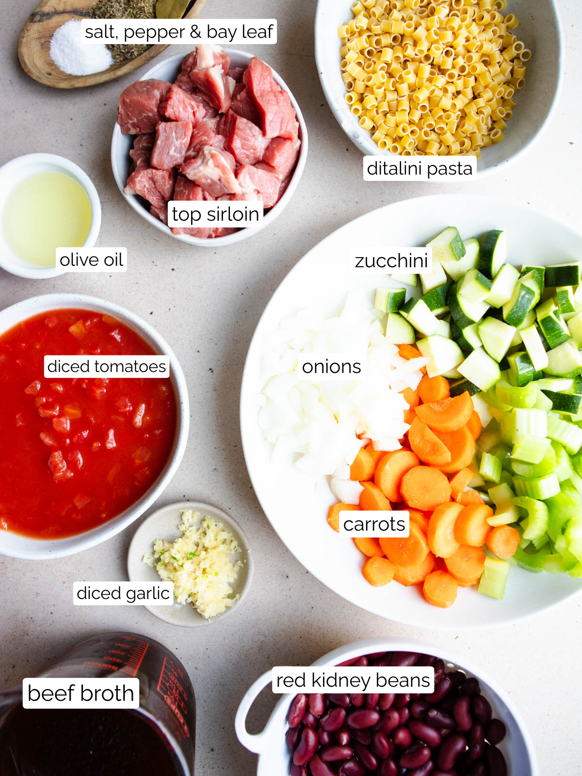 Minestrone soup ingredients in white bowls on a table
