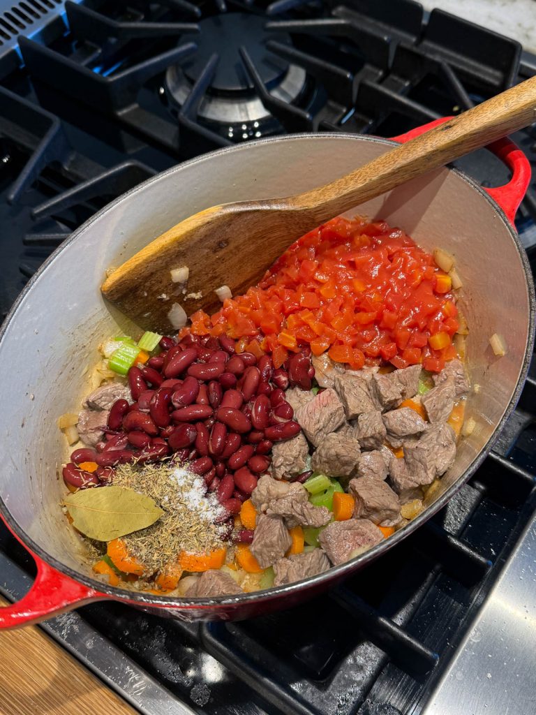 vegetables for Italian minestrone soup added to a Dutch oven pan
