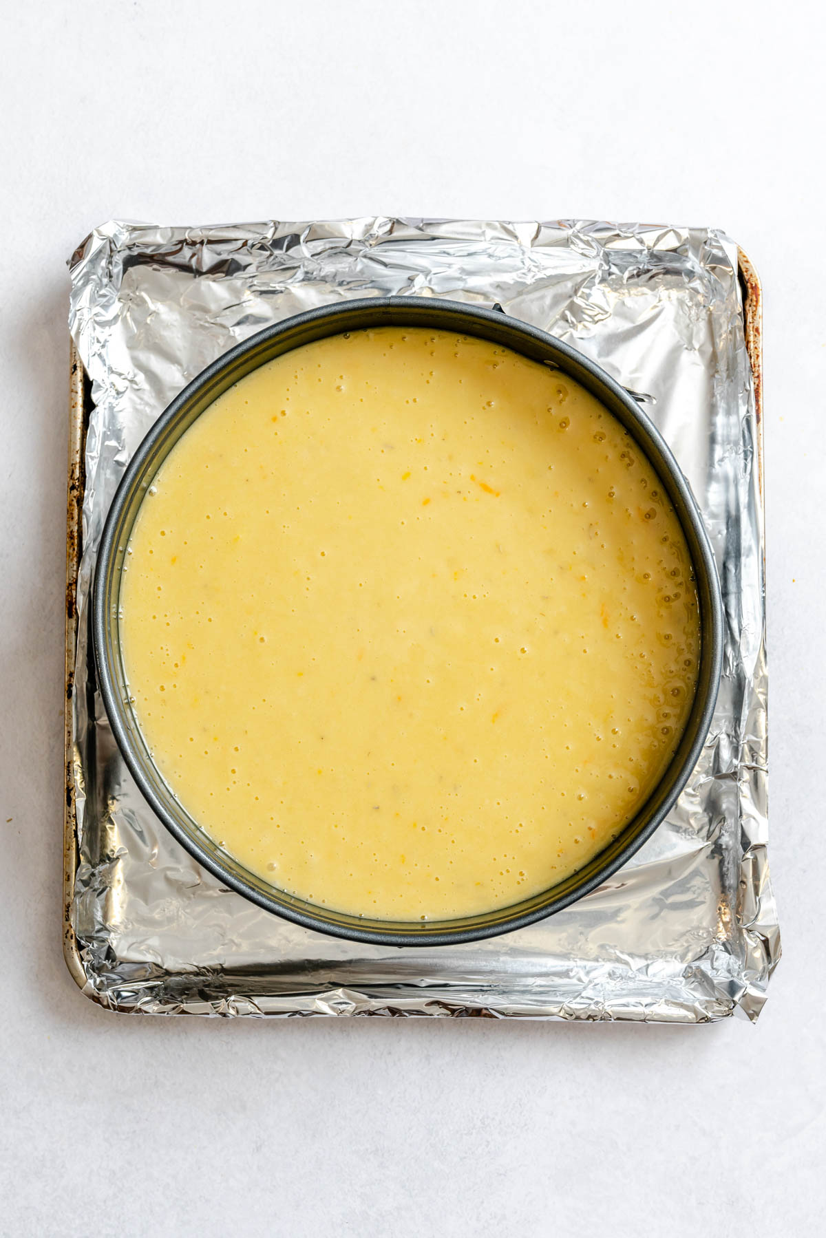 olive oil cake batter added to a springform pan
