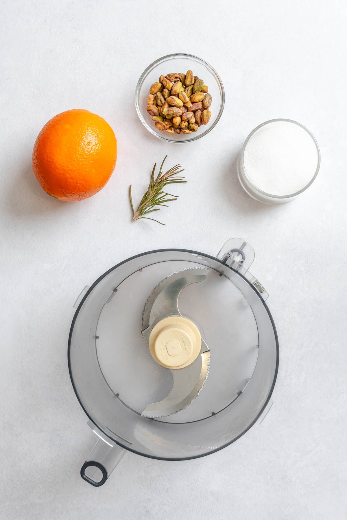 pistachio sugar topping ingredients and a food processor bowl