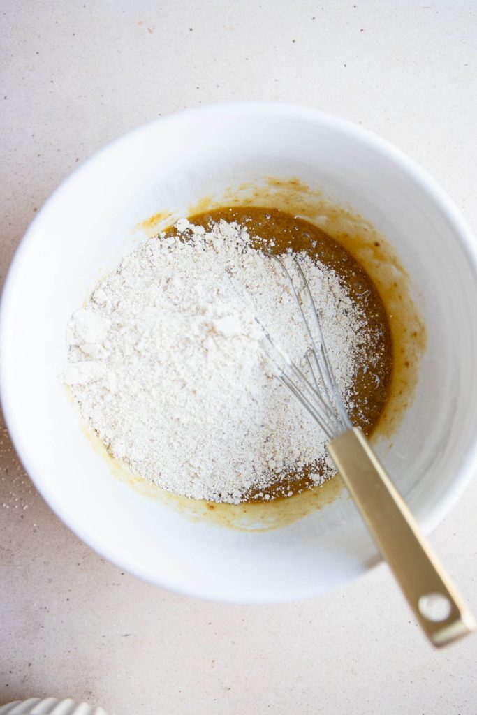 wet and dry ingredients for olive oil chocolate chip cookies added to the same bowl