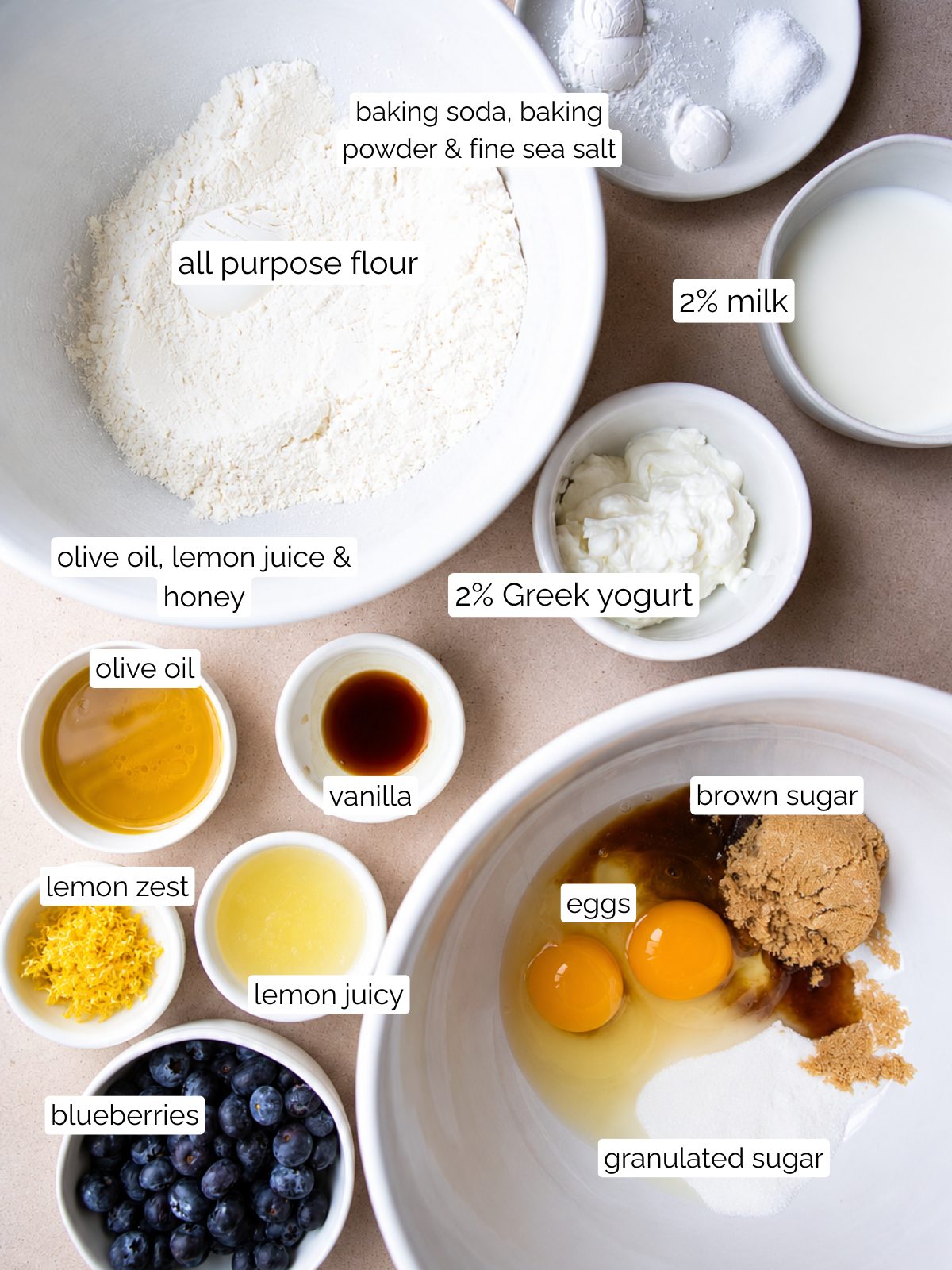 ingredients for lemon blueberry muffins made with olive oil and Greek yogurt in small white bowls