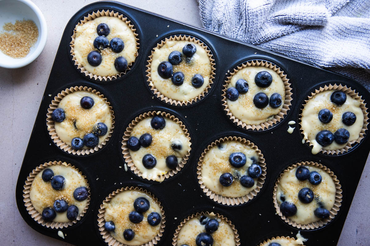 unbaked healthy blueberry muffins in muffin tins ready to be baked