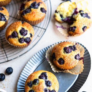 a table filled with lemon blueberry muffins