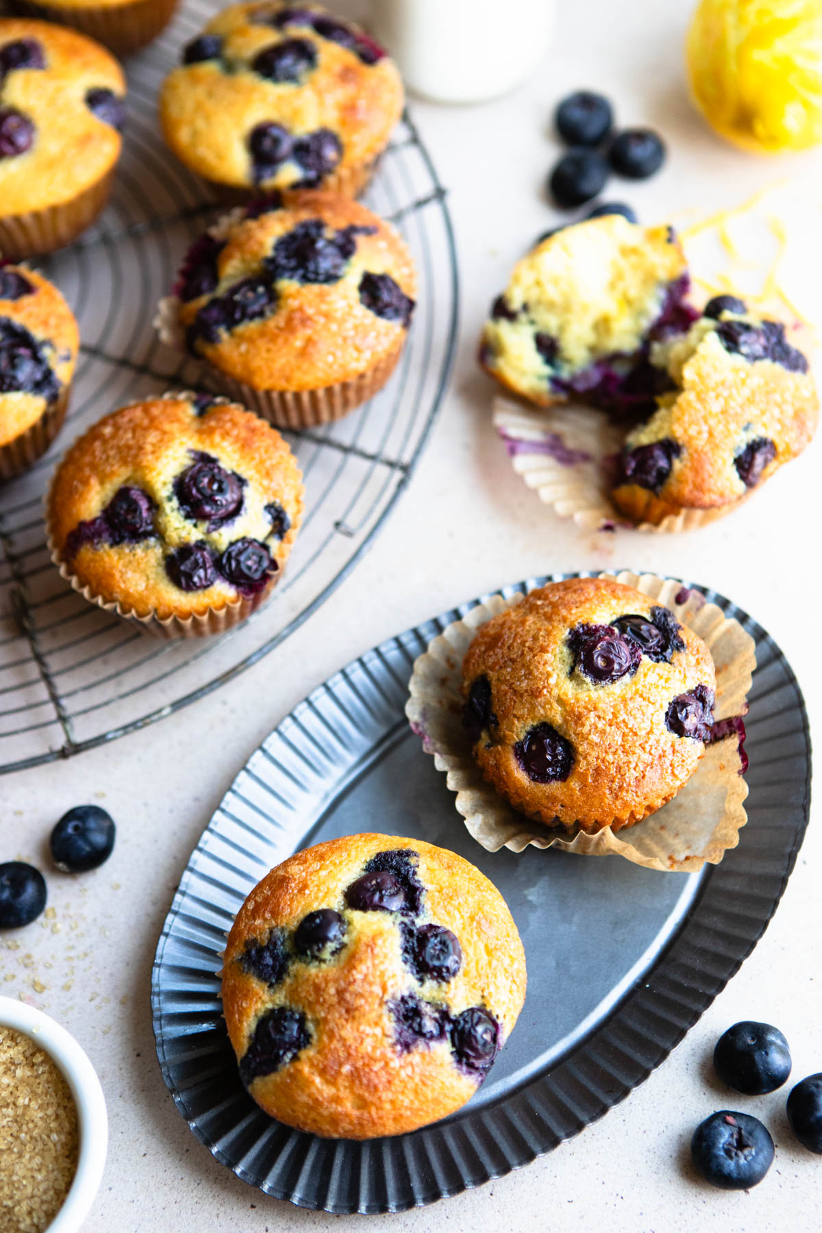 a table filled with lemon blueberry muffins