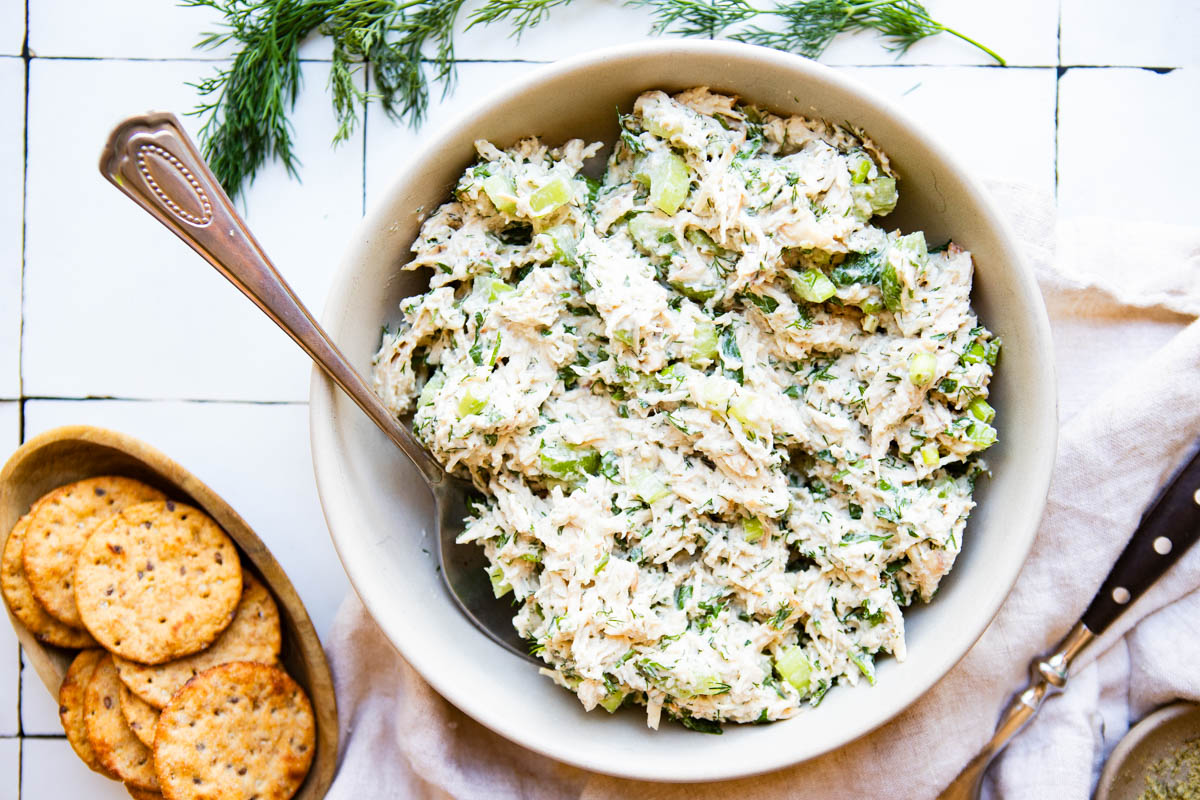 crackers and dill pickle chicken salad set on a table, ready to be eaten