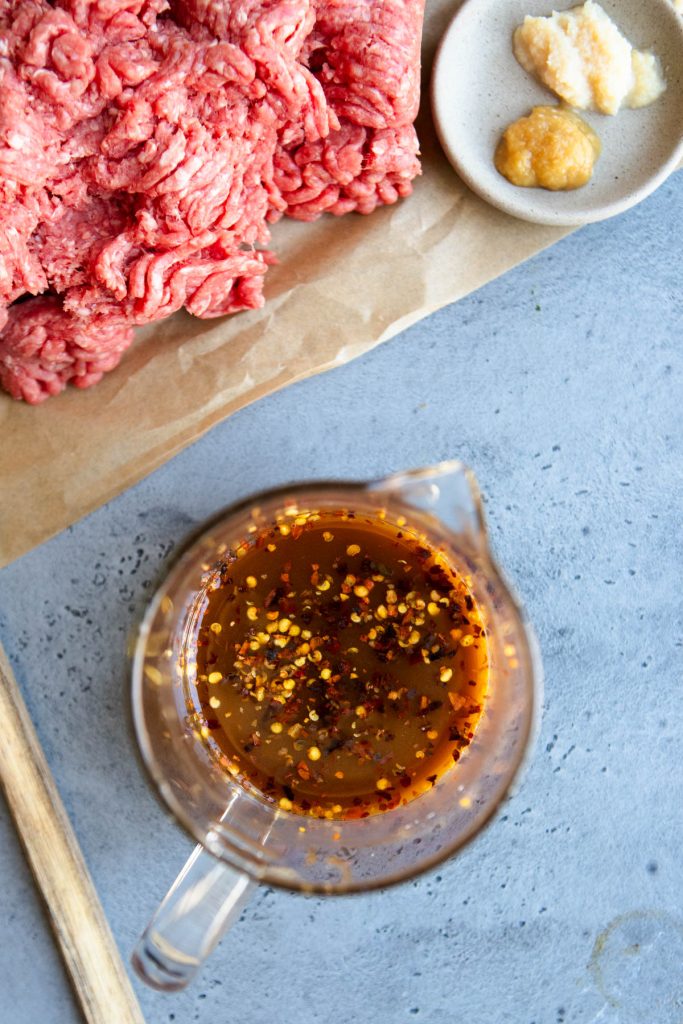 honey beef sauce in a glass measuring cup