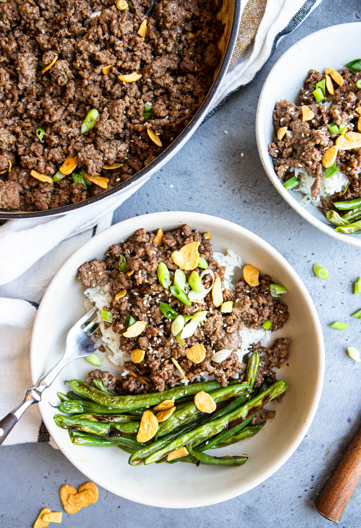white ceramic bowls filled with steamed rice and honey ground beef 