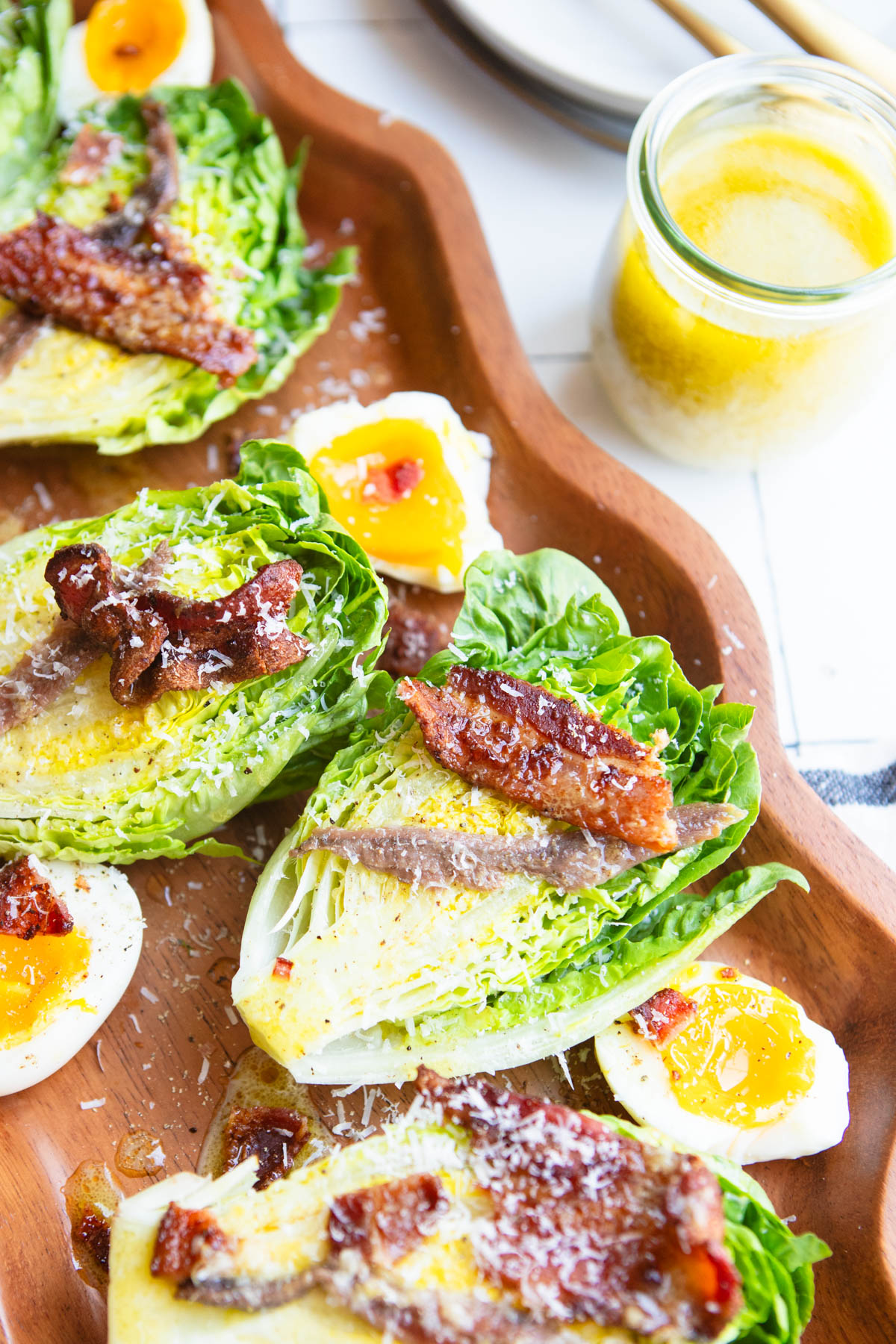 little gem lettuce halves topped with bacon and jammy eggs