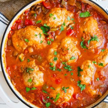 chicken cacciatore made with boneless skinless chicken thighs n a white cast iron skillet