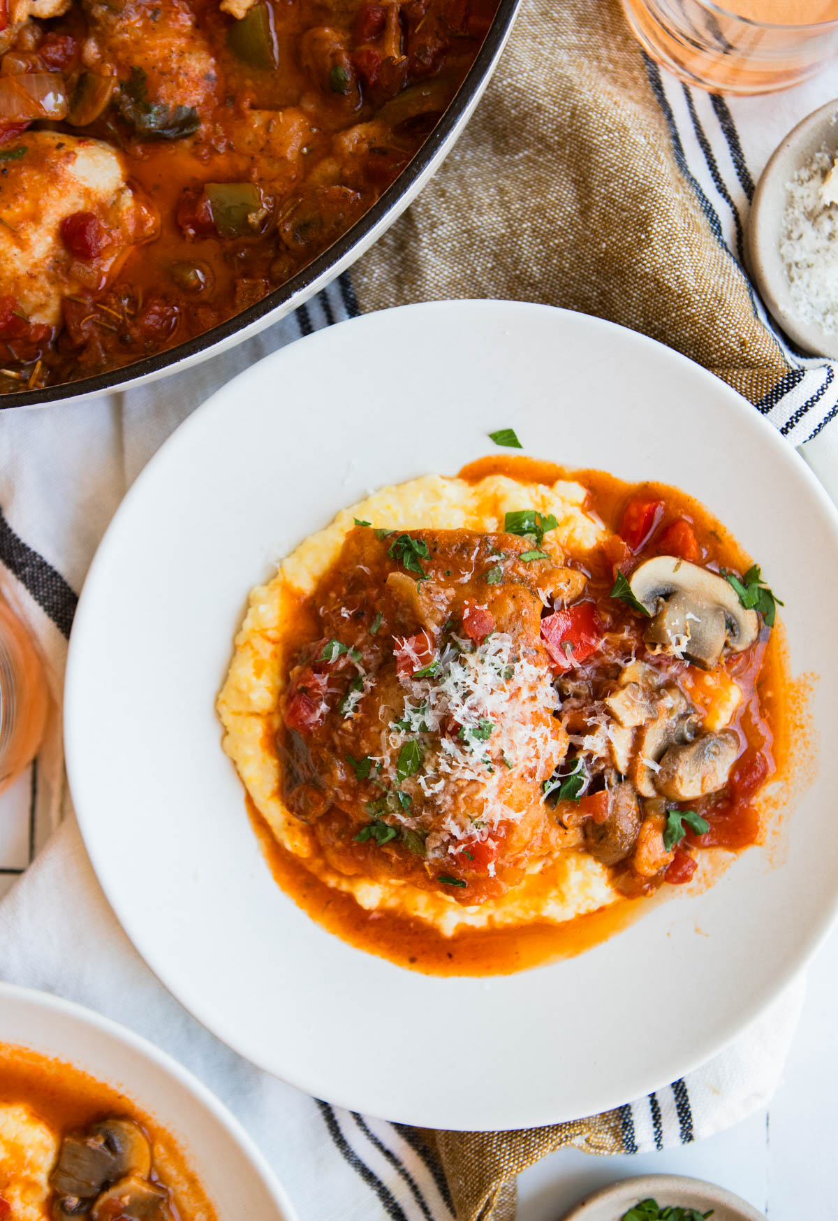 creamy polenta served with Italian chicken stew in a white dish