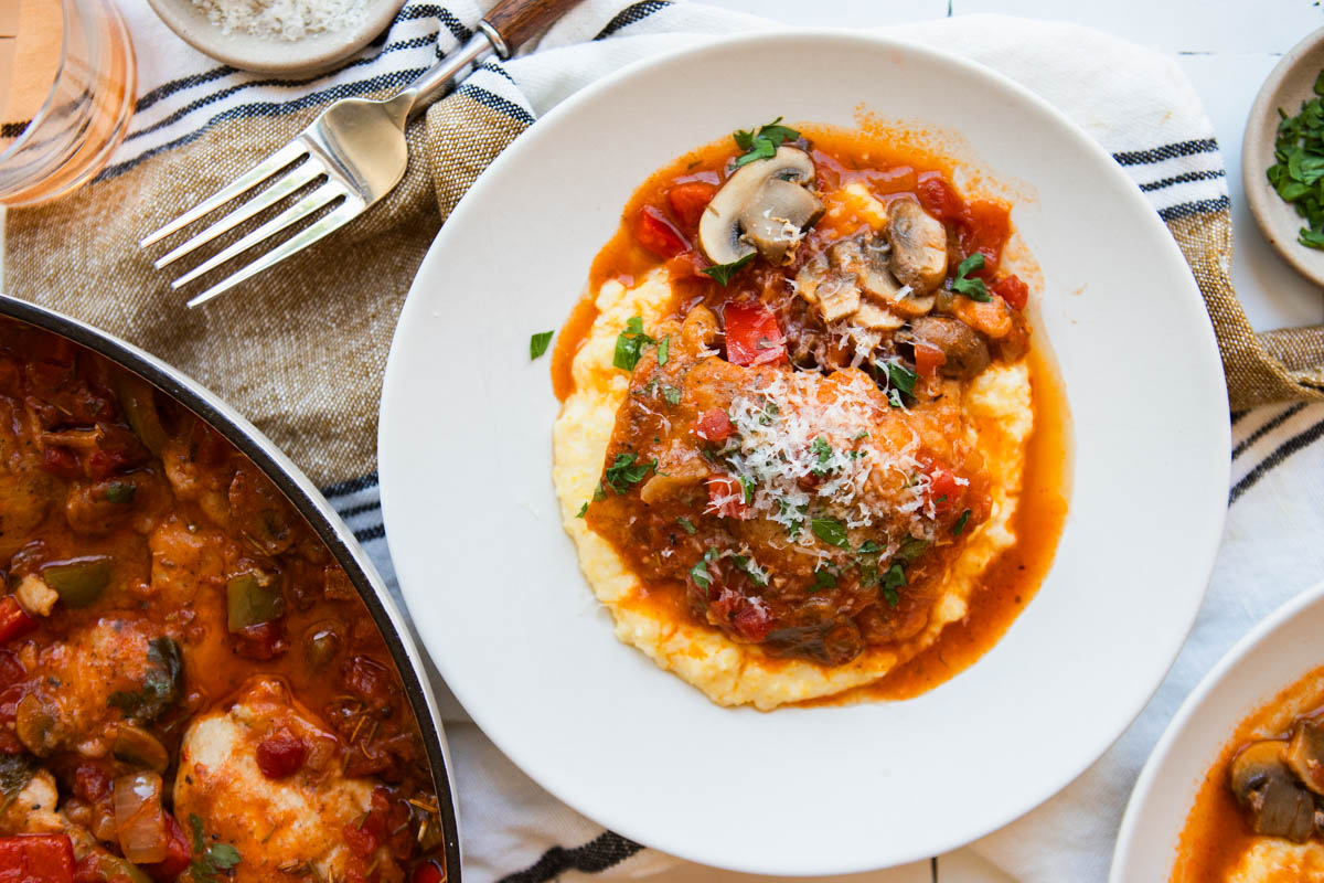 chicken cacciatore served over a bowl of polenta