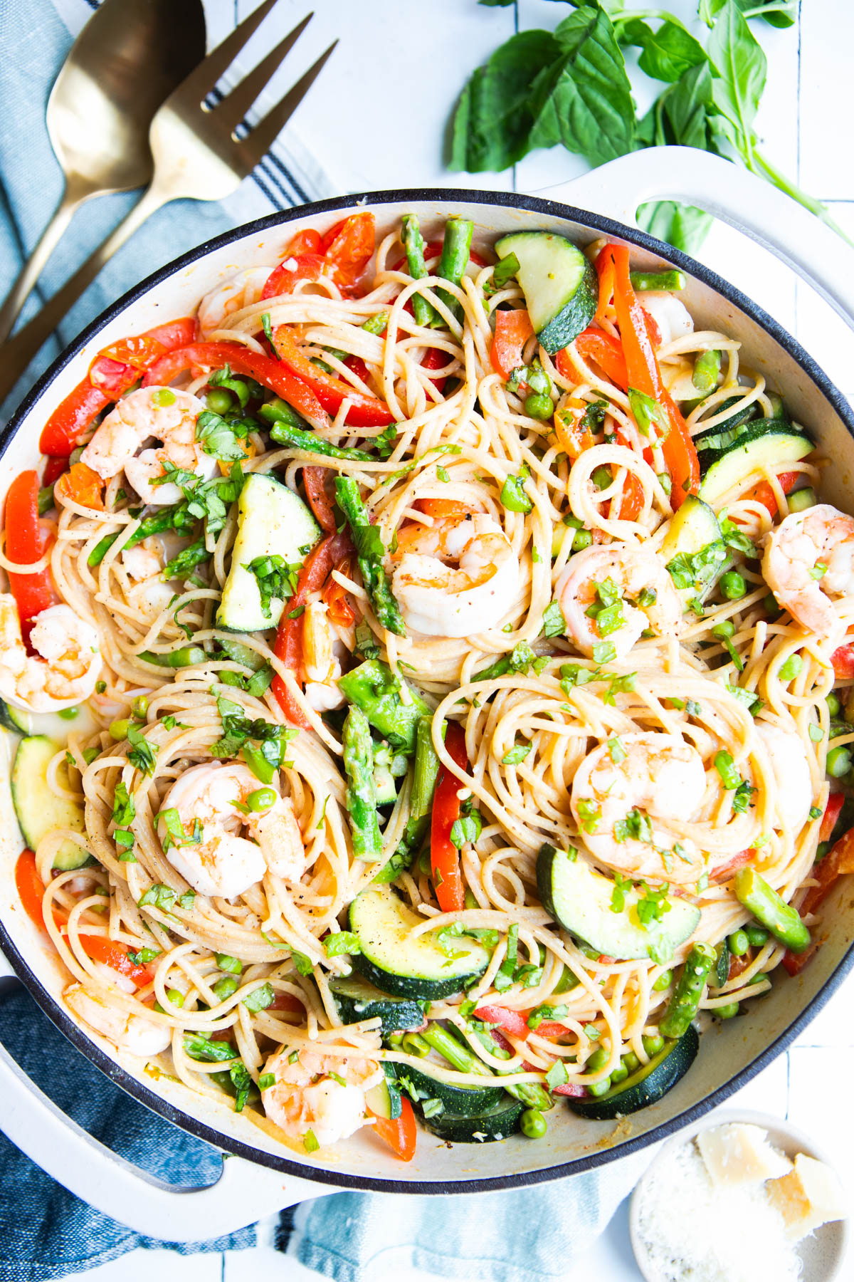 shrimp primavera pasta recipe in a large enameled cast iron skillet