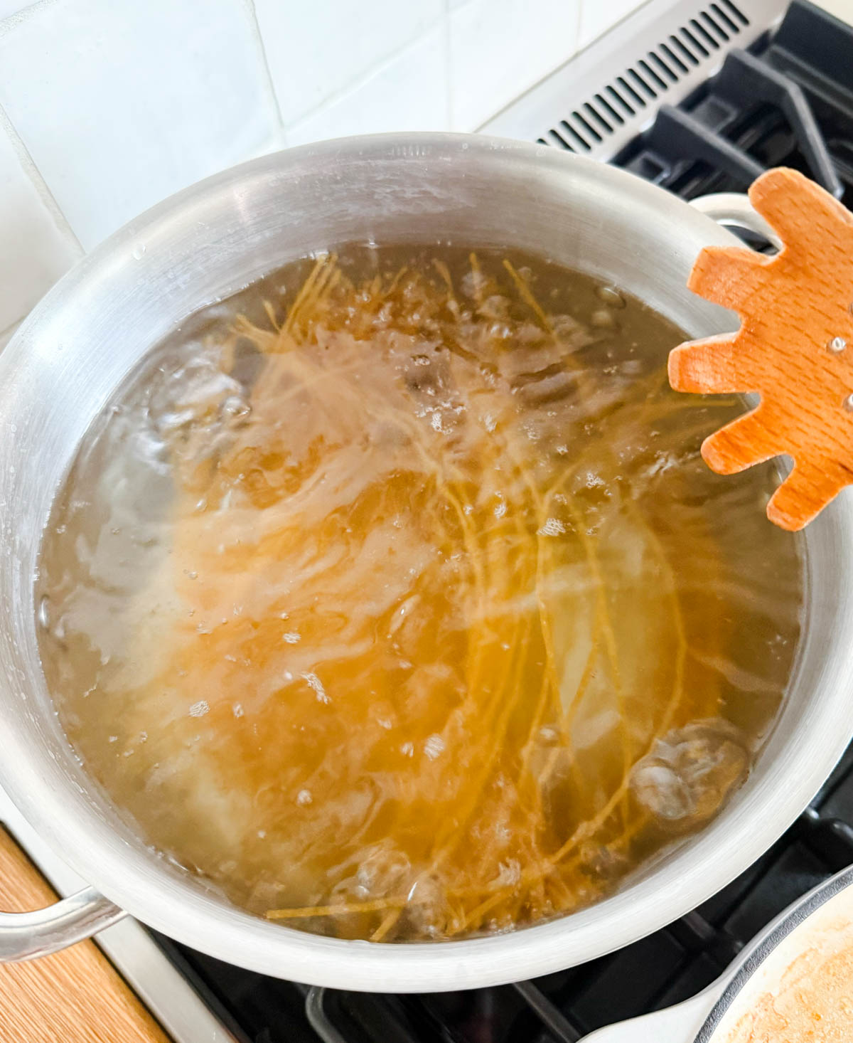 whole wheat spaghetti cooking in a pot of boiling water
