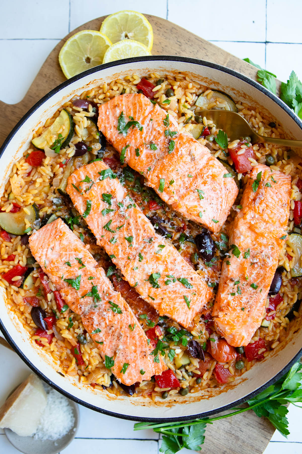 one pan Mediterranean salmon and orzo dinner garnished with parsley and parmesan cheese