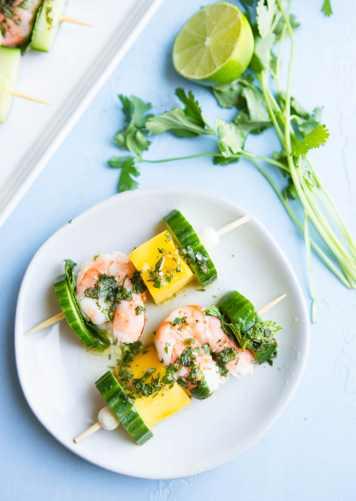 white plate filled with 2 mini shrimp skewers