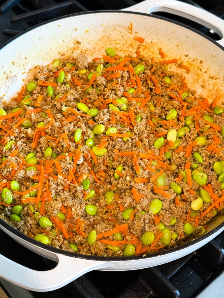 chili lime sauce added to ground turkey and veggie skillet to make Asian rice bowls