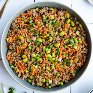 ground turkey rice bowls in a large gray bowl garnished with green onions and sesame seeds