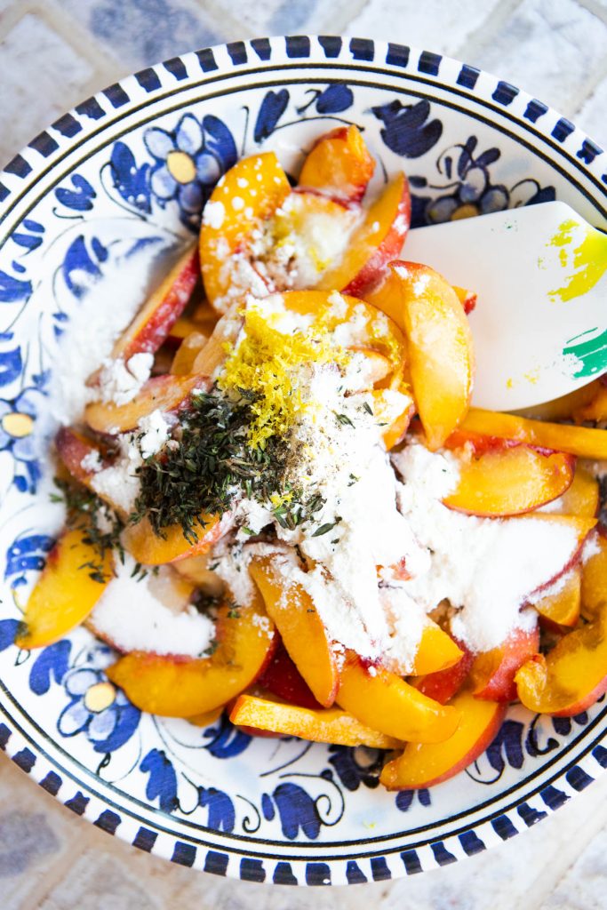 peach galette filling mixed in a blue and white floral bowl