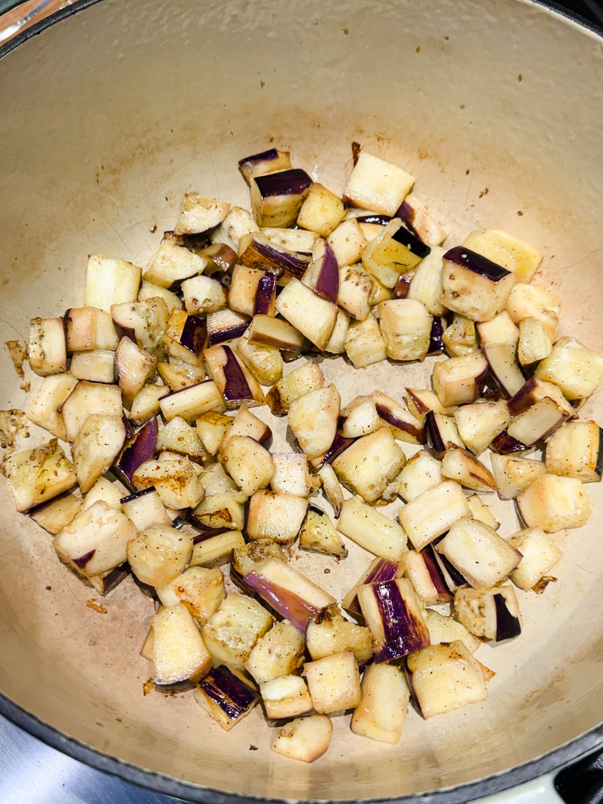 eggplant added to a large Dutch oven and sautéing