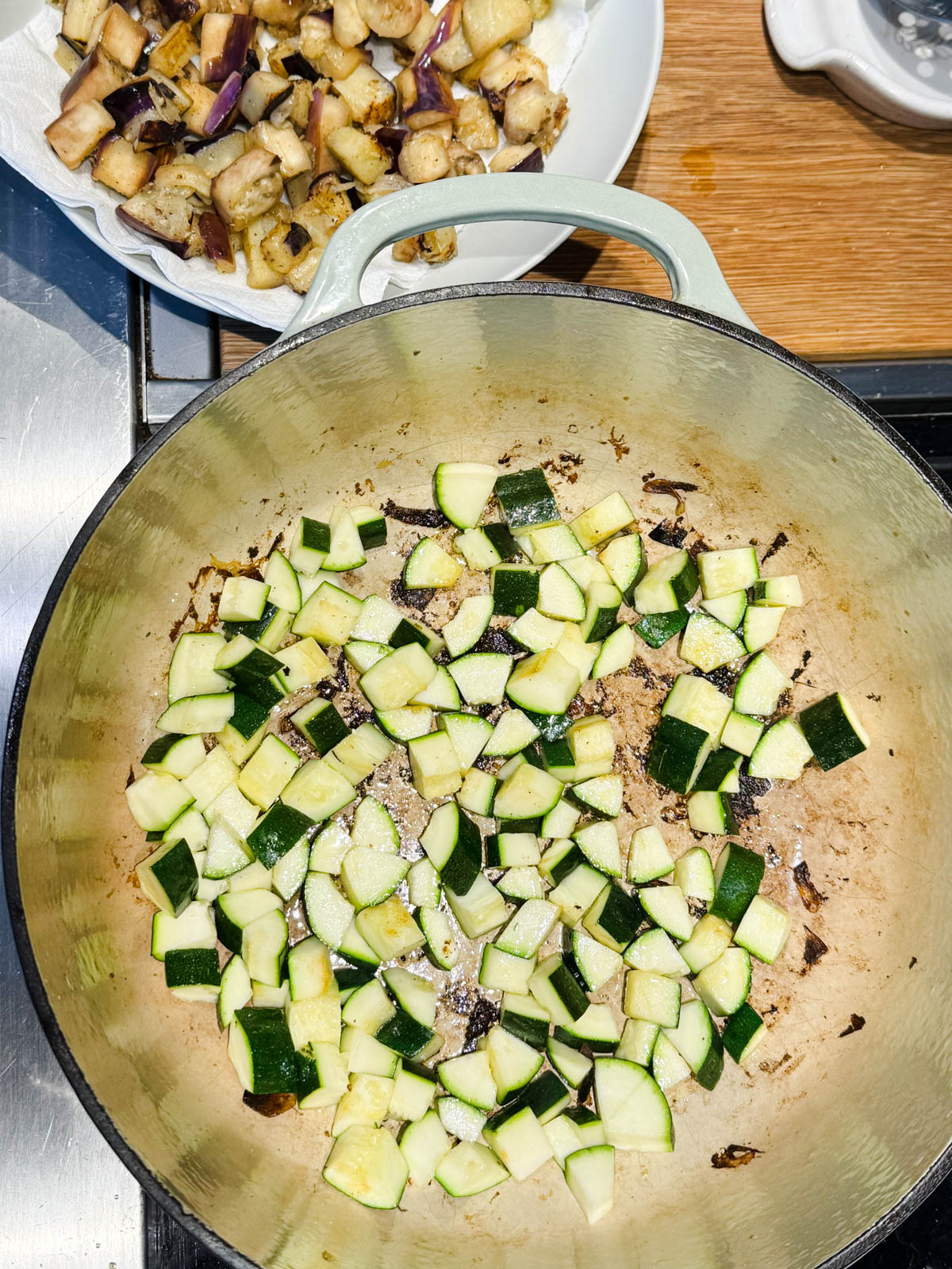 zucchini cooking in a heavy bottom large Dutch oven