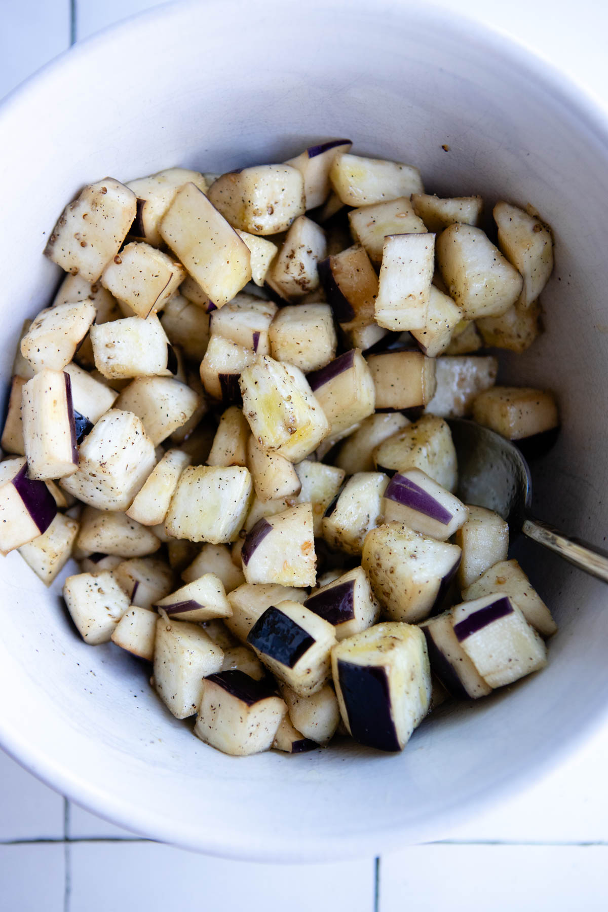 eggplant tossed with olive oil and ready to be cooked