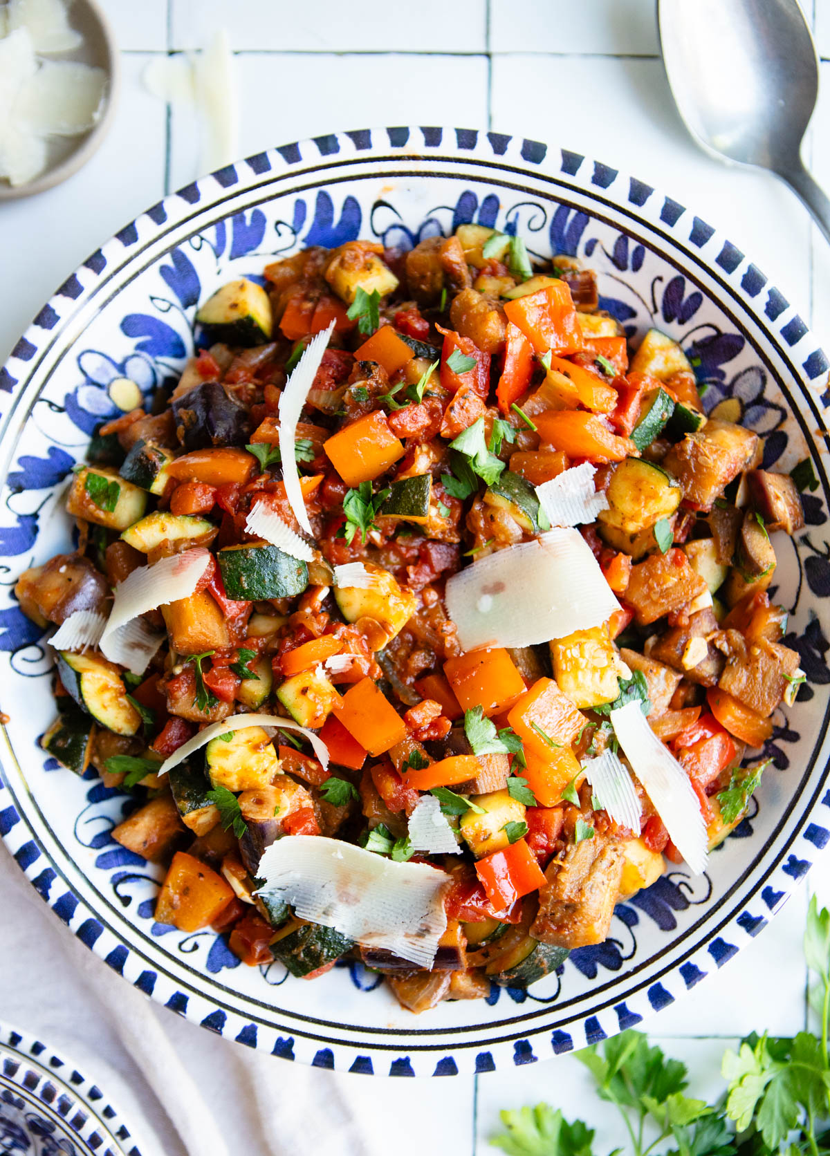 ratatouille placed in a serving dish and garnished with parmesan cheese and parsley