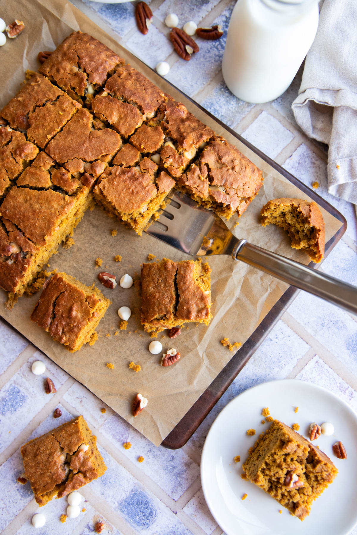 baked healthy pumpkin bars made with oat flour and white chocolate chips and pecans